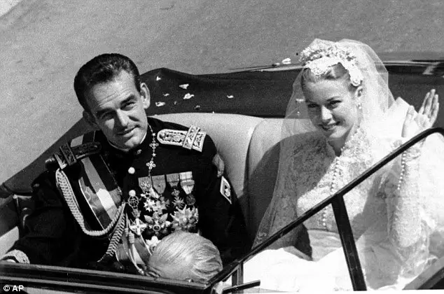 Royal couple riding in an open vehicle