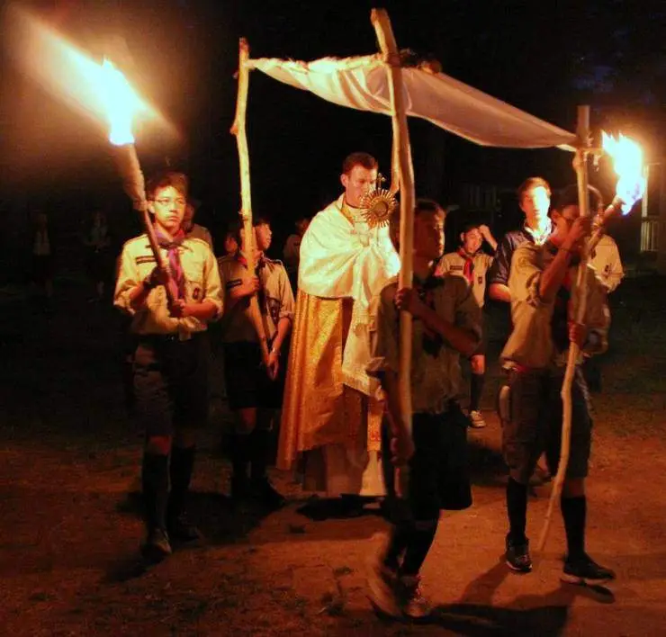 Scouts with priest carrying the Most Blessed Sacrament