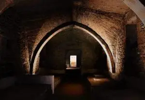 Stone monastic passage with light ahead, illustrating the Church year as a path with Christ