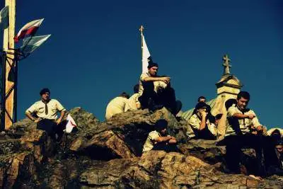 scouts sitting on a mountaintop with church