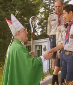 a bishop shaking hands with a scout