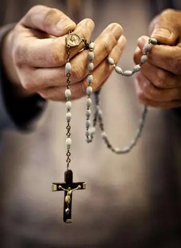 Hands holding rosary