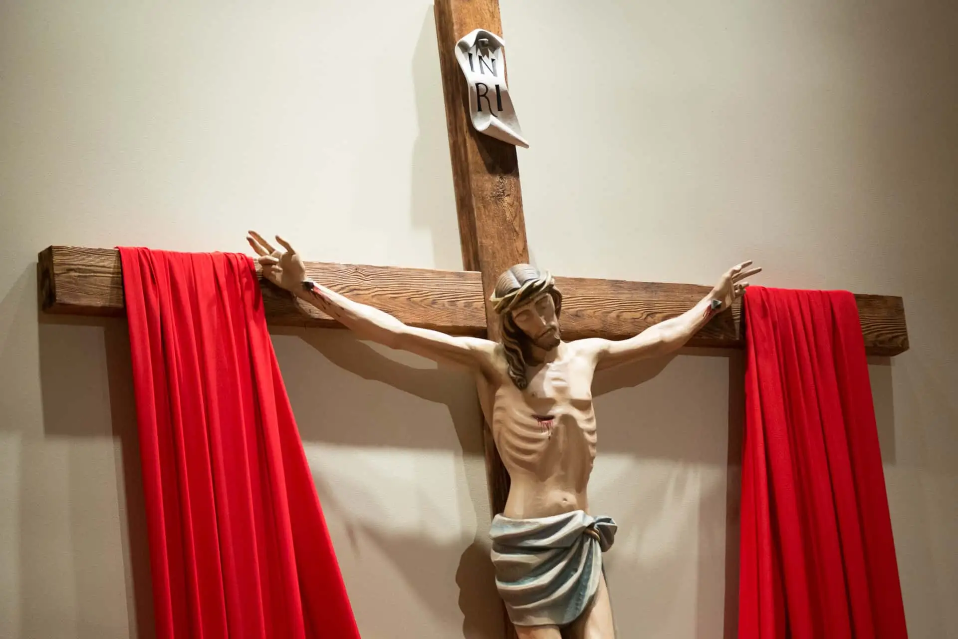 Crucifix with red cloth draped on it