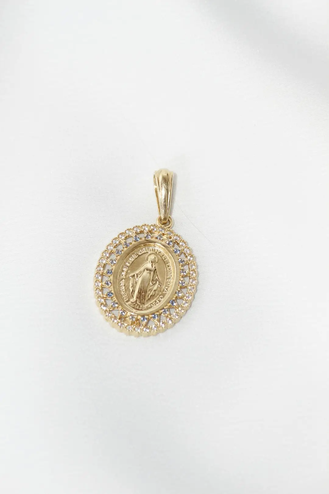 Miraculous Medal Novena image showing a gold medal of the Blessed Virgin Mary.