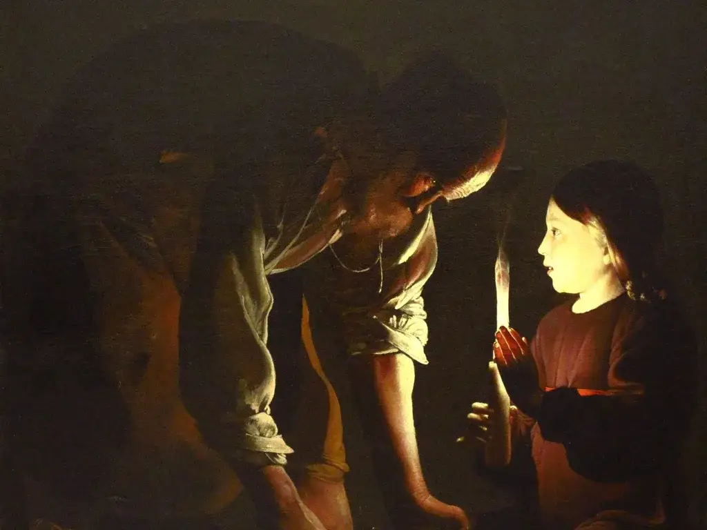 Georges de La Tour painting of St. Joseph working at his carpentry while the boy Jesus holds a candle